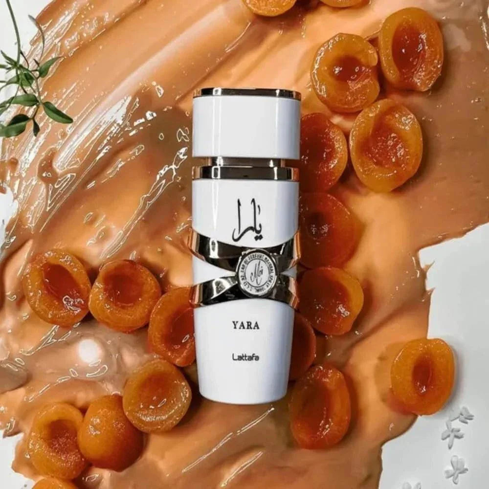 Lattafa Yara Moi floral fruity gourmand eau de parfum bottle with apricot fruit on creamy background