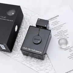 Armaf Club De Nuit intense men perfume bottle with black packaging on textured surface
